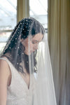 A model wearing MARIBEL II two tier pearl wedding veil by Madame Tulle