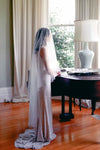 A model wearing MARIBEL II two tier pearl wedding veil by Madame Tulle