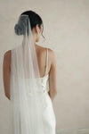 A model wearing a one tier wedding veil with crystals by Madame Tulle