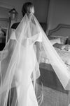 A bride wearing the ELLA I minimalist one tier wedding veil, a black and white photo