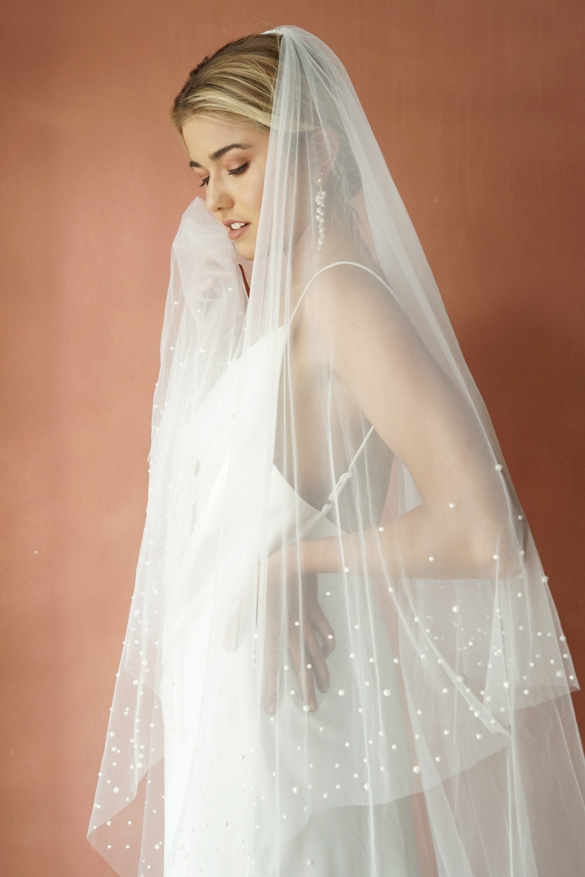 A model wearing ESTELLE, a two tier pearl wedding veil by Madame Tulle bridal