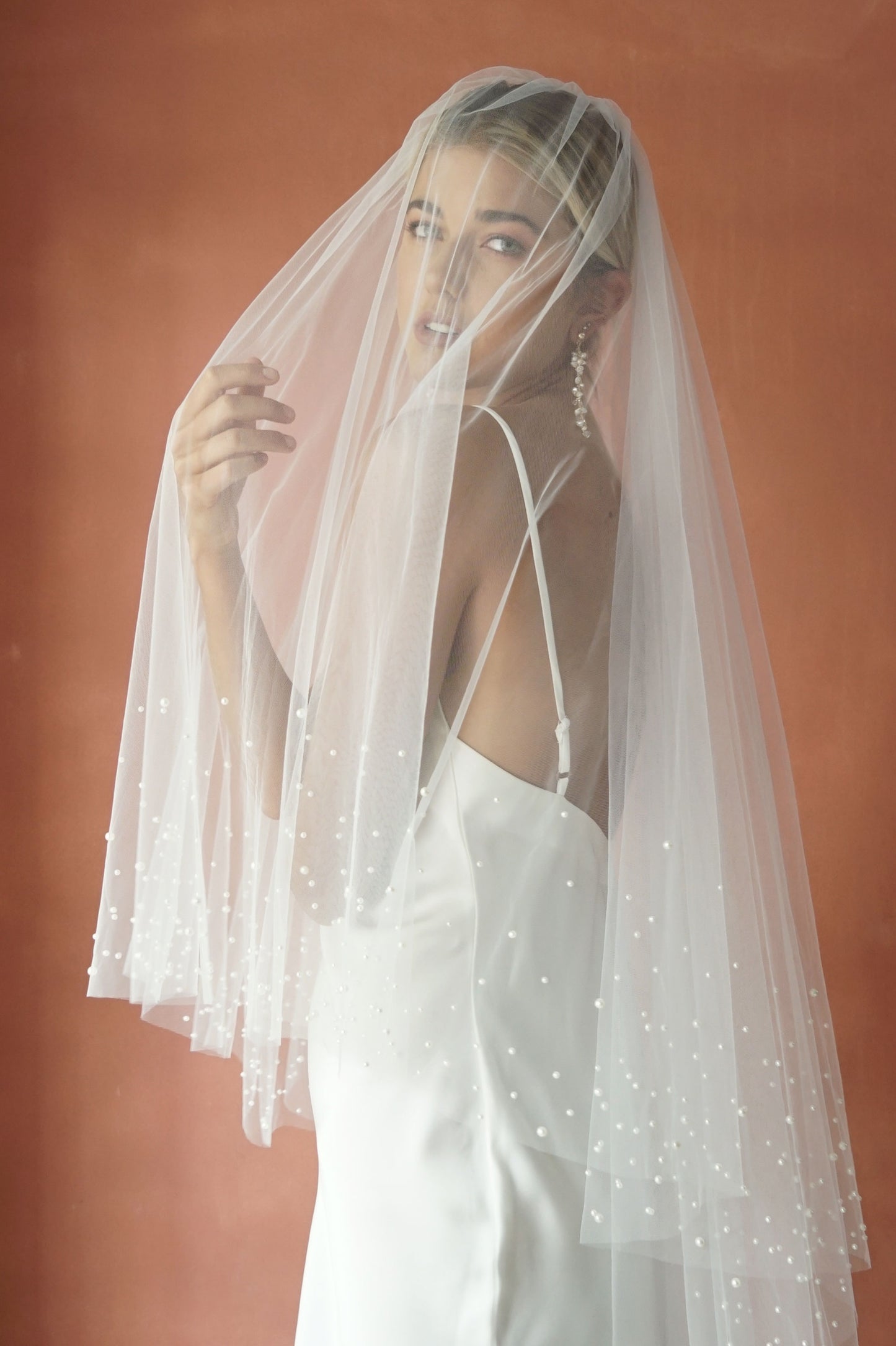A model wearing ESTELLE, a two tier pearl wedding veil by Madame Tulle bridal