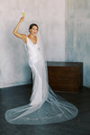 A model wearing embroidered wedding veil in cathedral length with text happily ever after