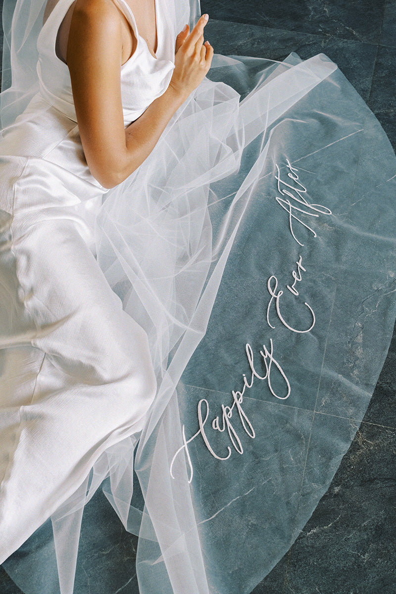 A wedding veil with embroidery text happily ever after