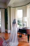 A model wearing MARIBEL I one tier pearl wedding veil by Madame Tulle