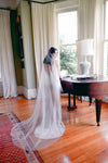 A model wearing MARIBEL I one tier pearl wedding veil by Madame Tulle