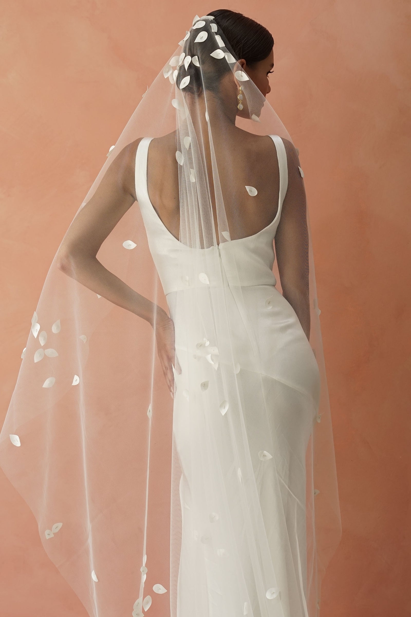model wears a one-tier petal veil, wedding veil with satin petal and glass beads