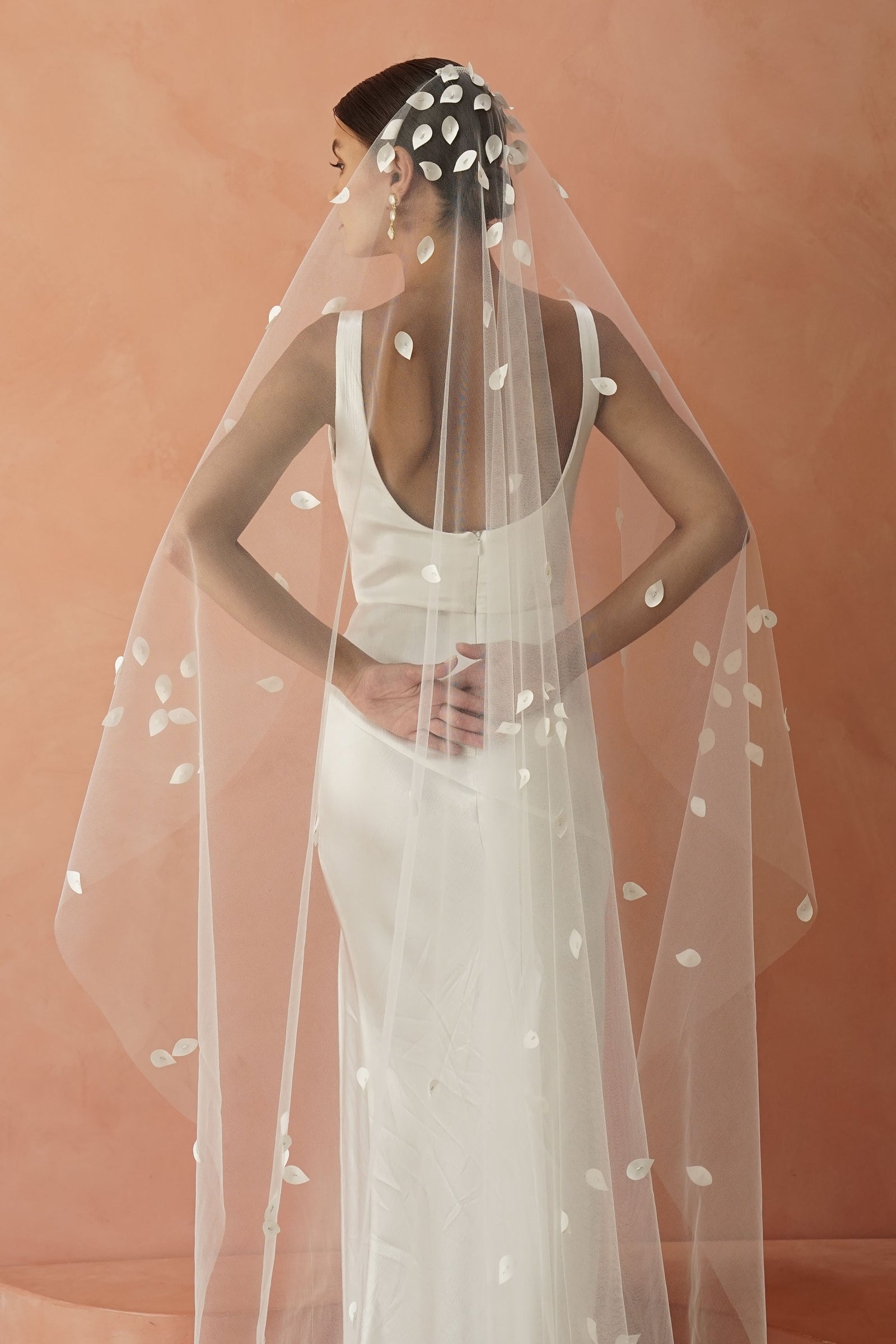 model wears a one-tier petal veil, wedding veil with satin petal and glass beads