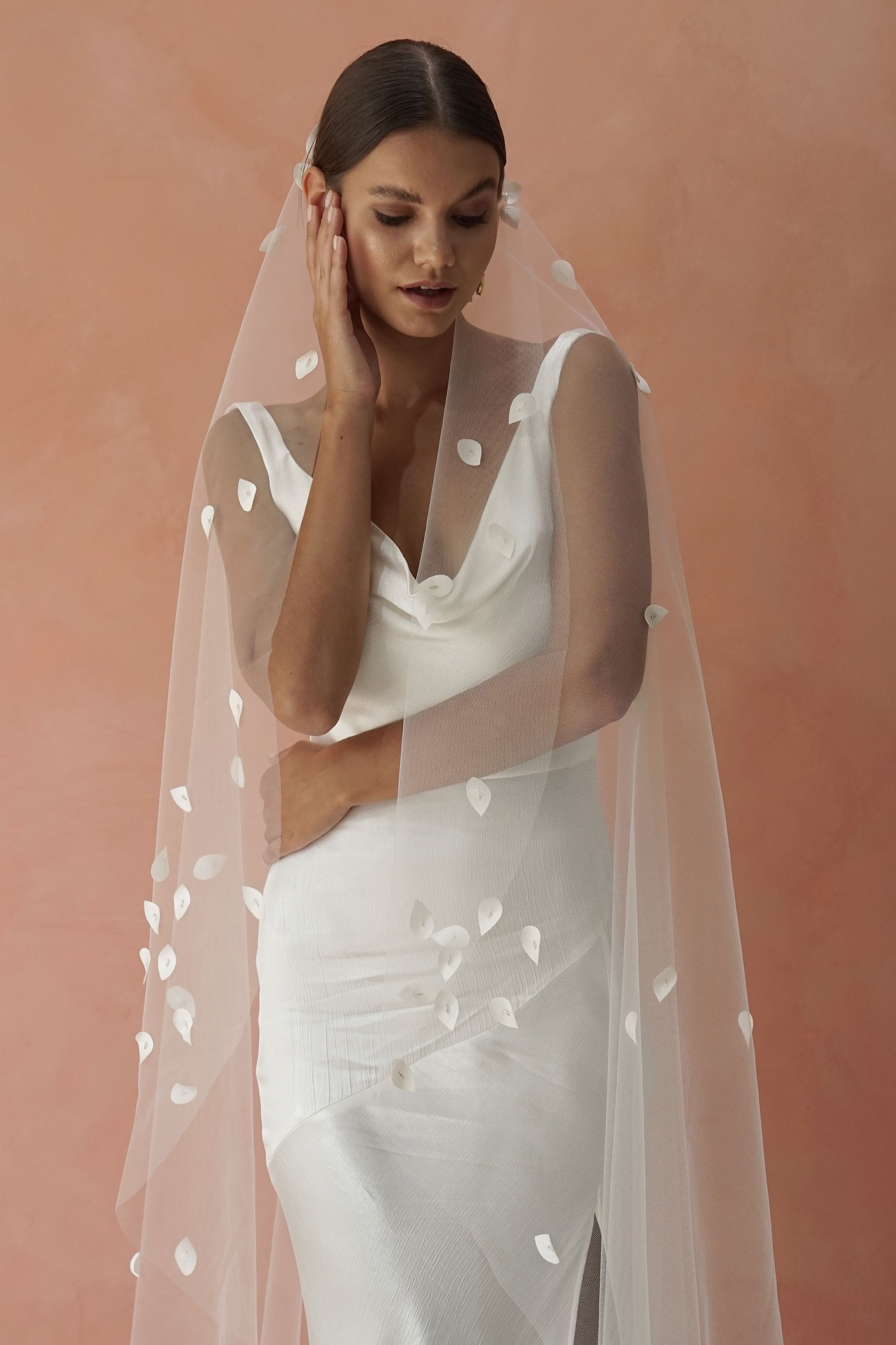 model wears a one-tier petal veil, wedding veil with satin petal and glass beads