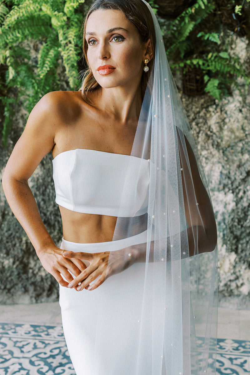 A model wearing a one tier pearl wedding veil 