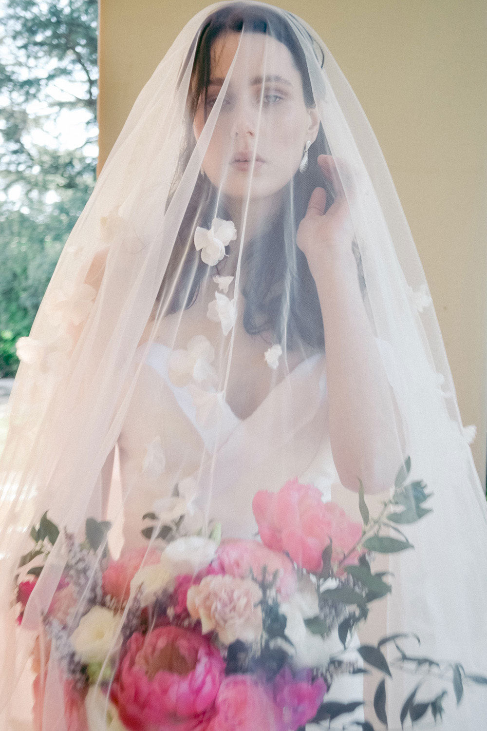 model wears a handmade three-dimensional fabric flowers wedding veil, floral veil