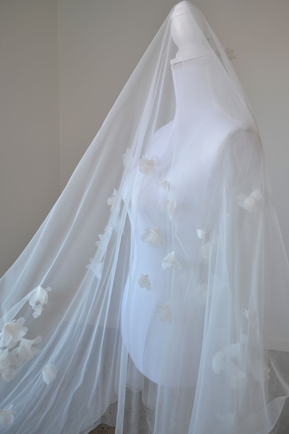 model wears a handmade three-dimensional fabric flowers wedding veil, floral veil