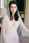 A model wearing Mathilde, a one tier pearl wedding veil by Madame Tulle
