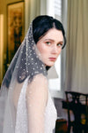 A model wearing Mathilde, a one tier pearl wedding veil by Madame Tulle