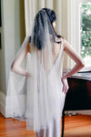 A model wearing Mathilde, a one tier pearl wedding veil by Madame Tulle