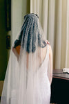 A model wearing Mathilde, a one tier pearl wedding veil by Madame Tulle