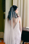 A model wearing Mathilde, a one tier pearl wedding veil by Madame Tulle