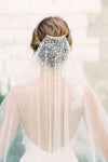 A model wearing Mathilde, a one tier pearl wedding veil by Madame Tulle