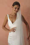 A model wearing a beaded pearl edge wedding veil