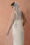 A model wearing a beaded pearl edge wedding veil