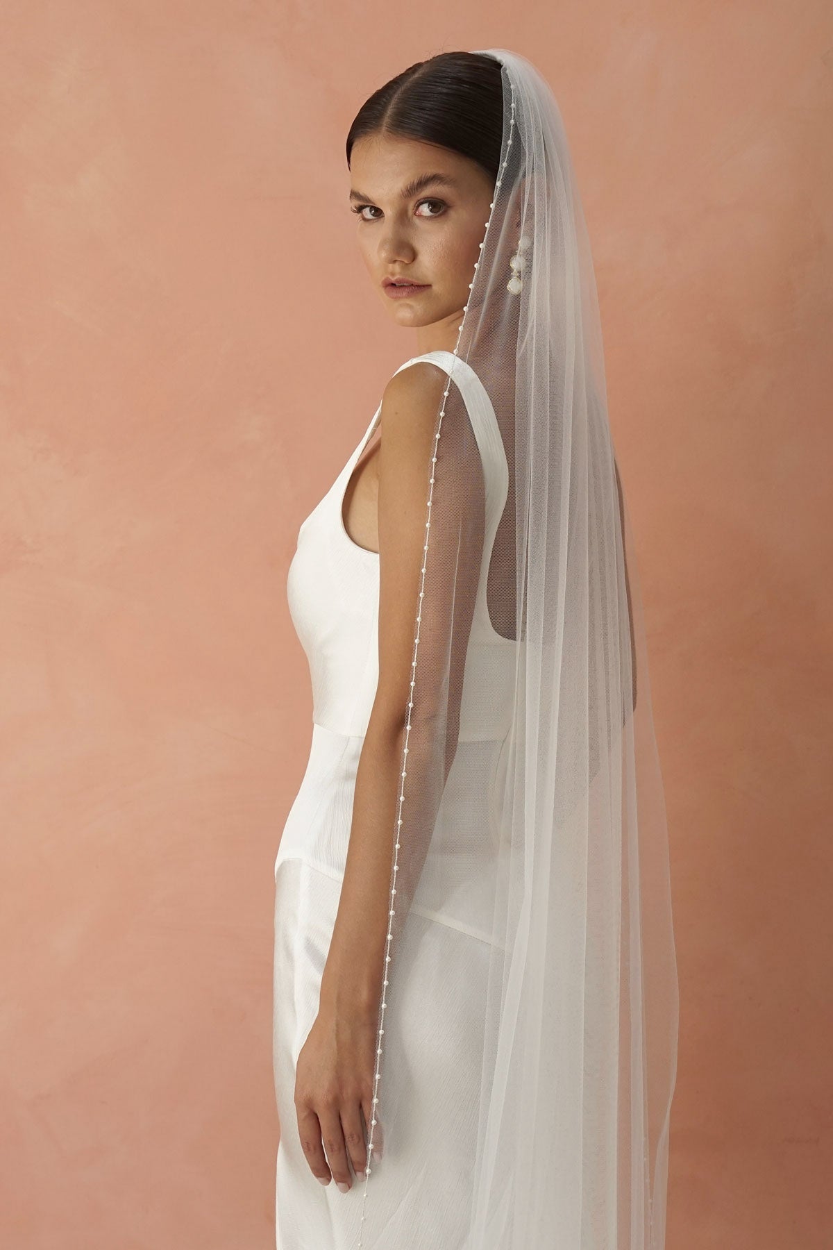 A model wearing a pearl edge wedding veil