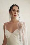 A model wearing a one tier satin cord edge wedding veil