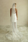 A model wearing the CHLOE one tier wedding veil with small pearls