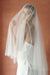 A model wearing ESTELLE, a two tier pearl wedding veil by Madame Tulle bridal