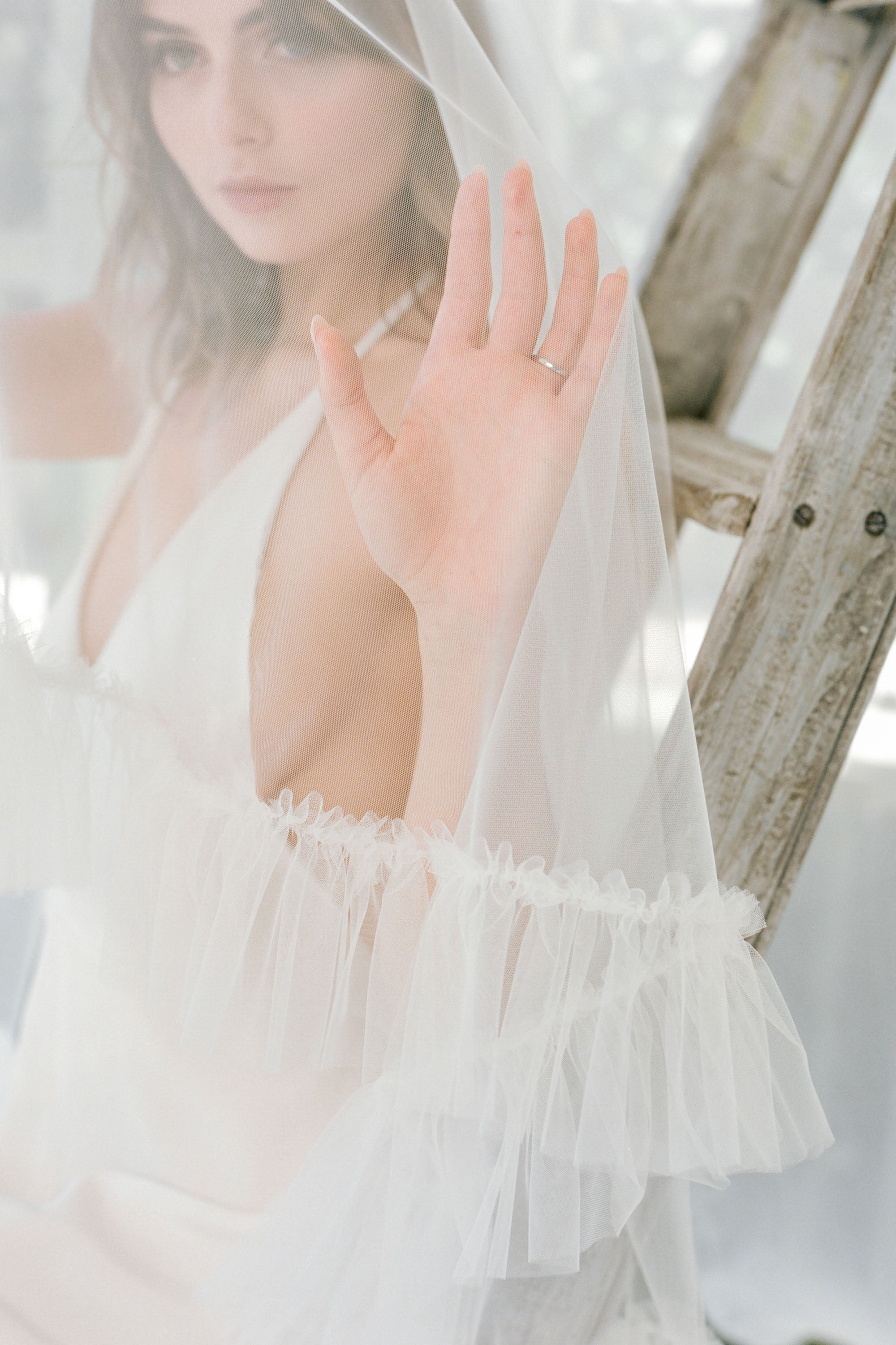 model wears a ruffle drop wedding veil