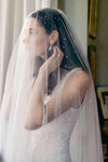 A model wearing STELLA II, a two tier wedding veil with crystals by Madame Tulle