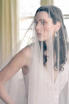 A model wearing STELLA II, a two tier wedding veil with crystals by Madame Tulle