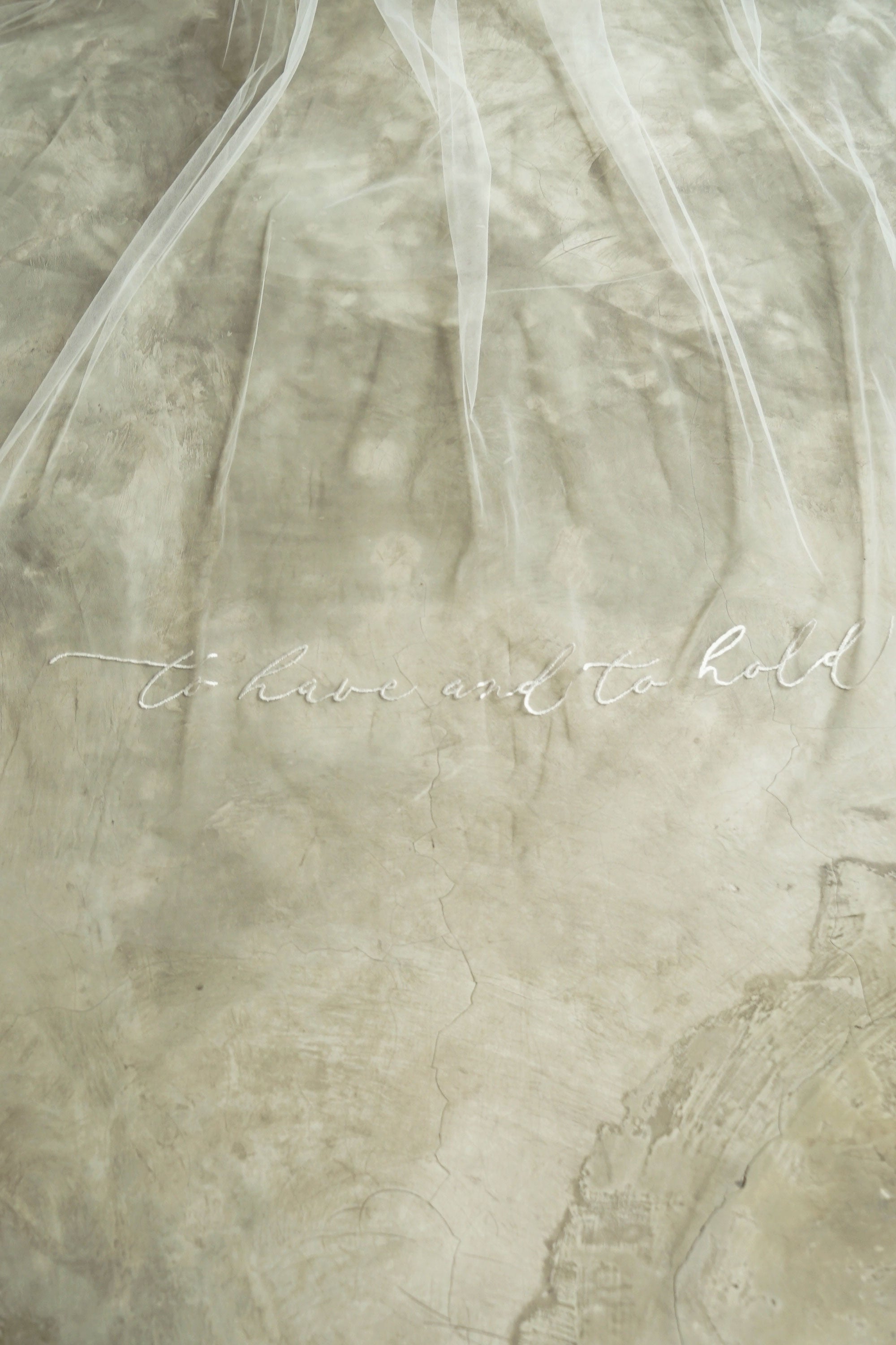A wedding veil with embroidery text to have and to hold