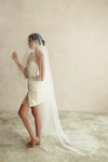 A model wearing a two tier satin cord edge wedding veil