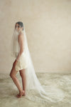 A model wearing a two tier satin cord edge wedding veil
