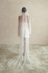 A model wearing a two tier satin cord edge wedding veil