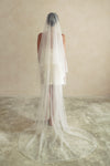 A model wearing a two tier satin cord edge wedding veil