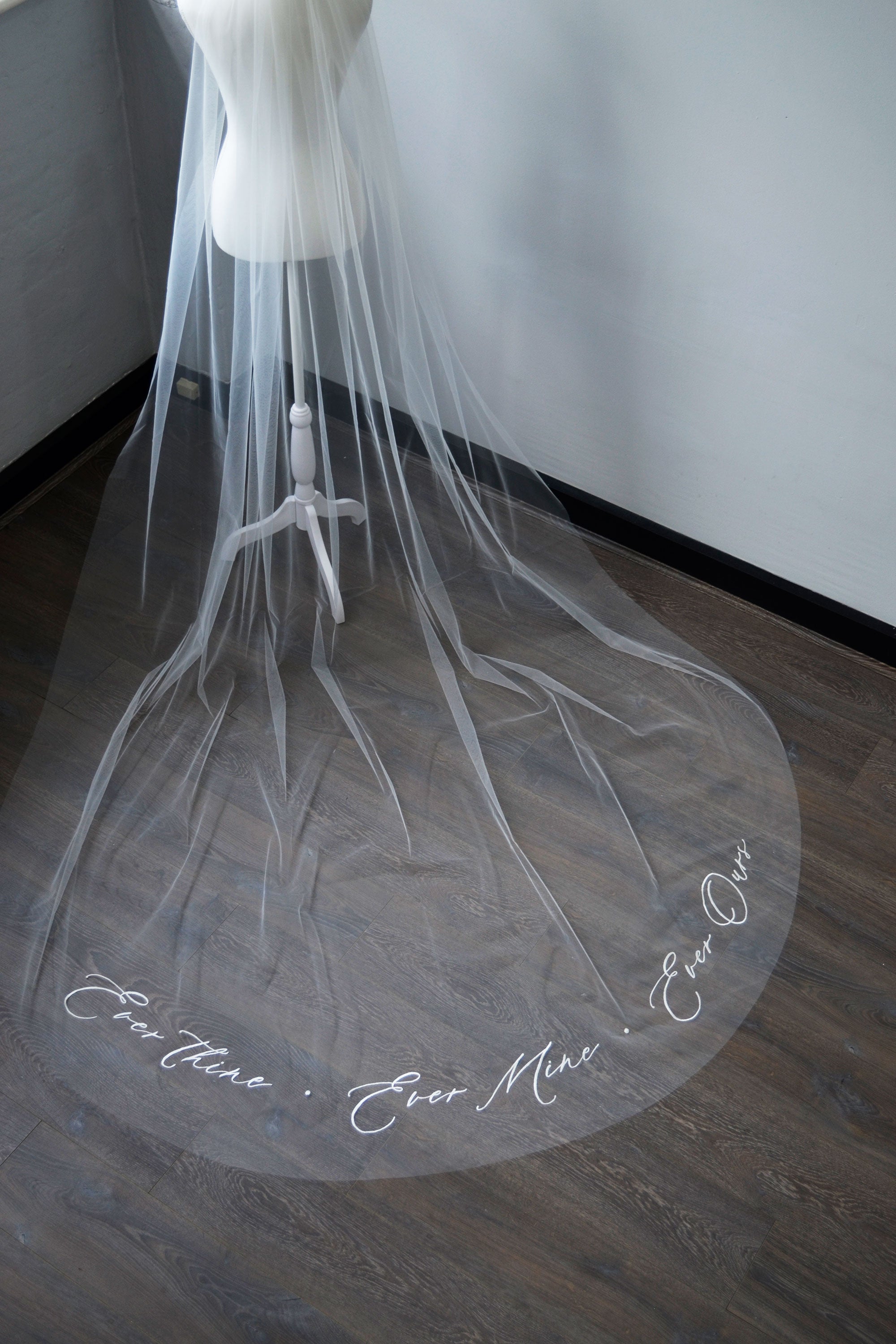 A wedding veil with embroidery text ever thine, ever mine, ever ours