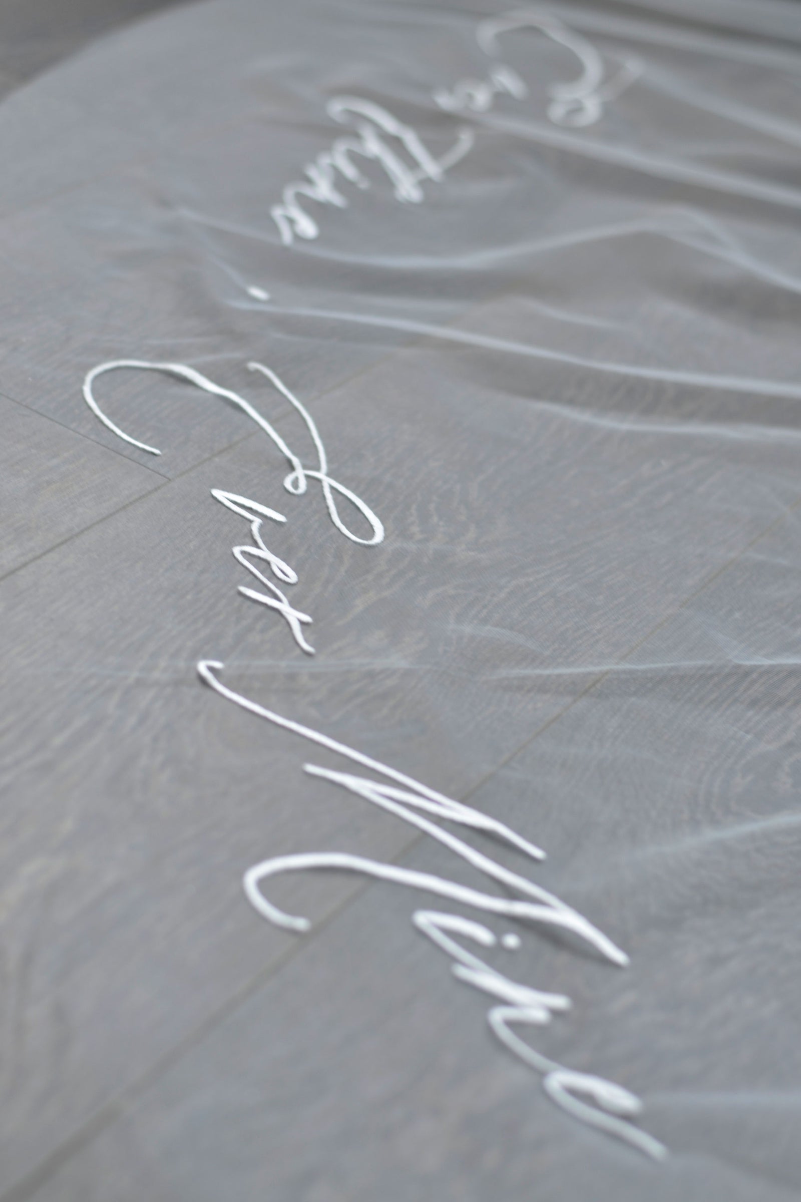 A wedding veil with embroidery text ever thine, ever mine, ever ours