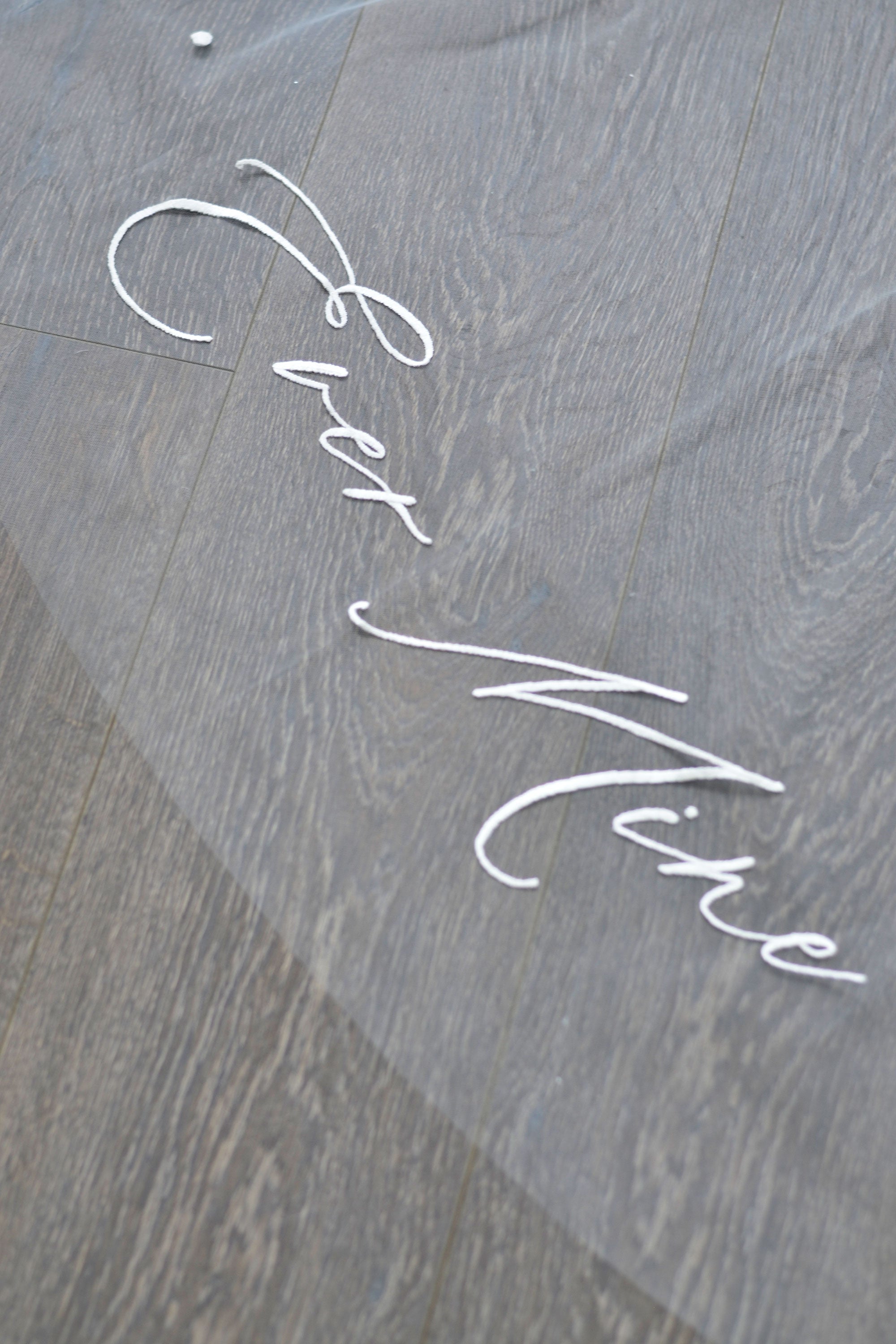 A wedding veil with embroidery text ever thine, ever mine, ever ours