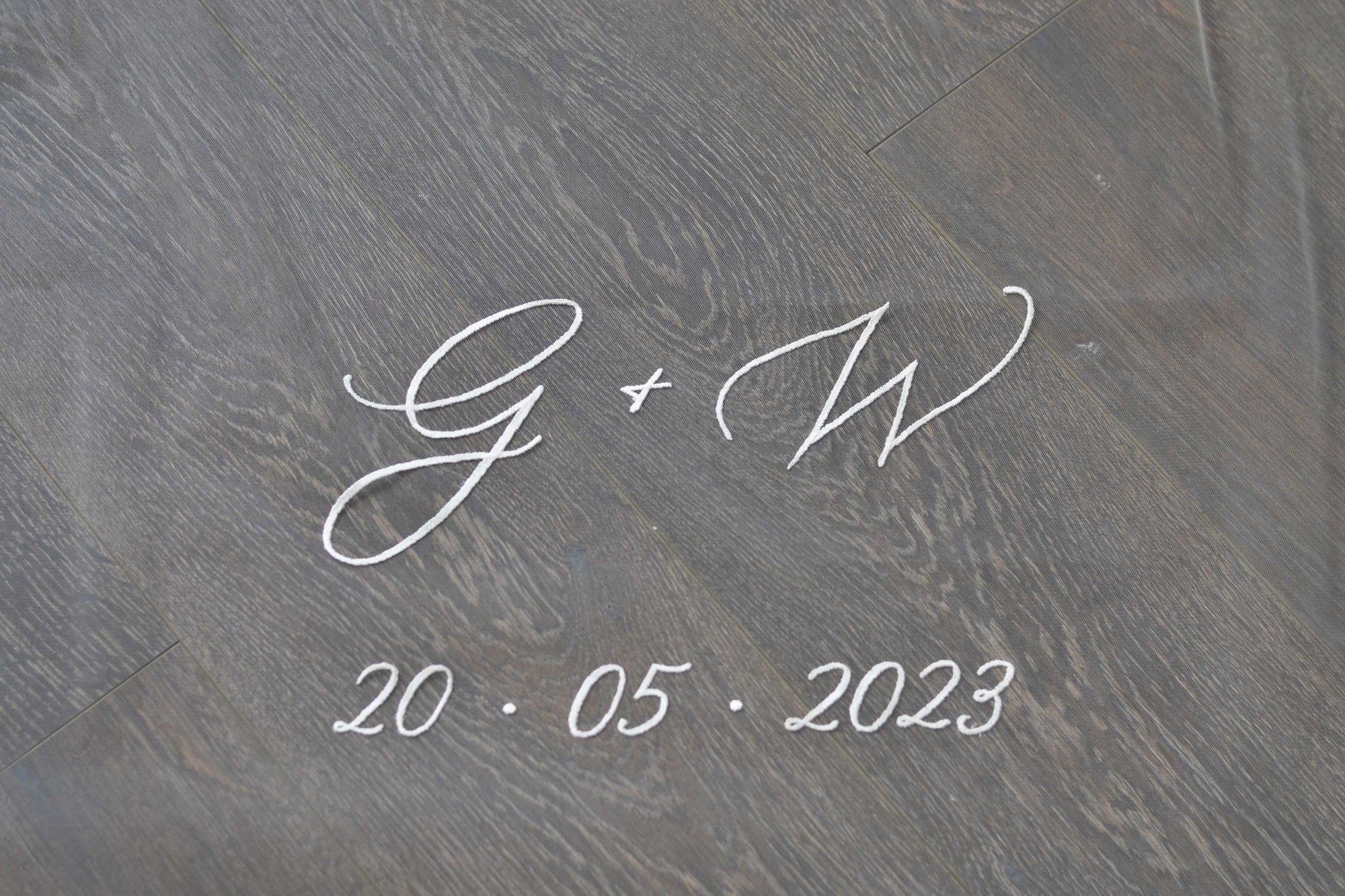 A wedding with personalised embroidery bride and groom&#39;s initials and wedding date