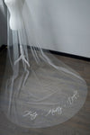 A wedding veil with embroidery text truly, madly, deeply