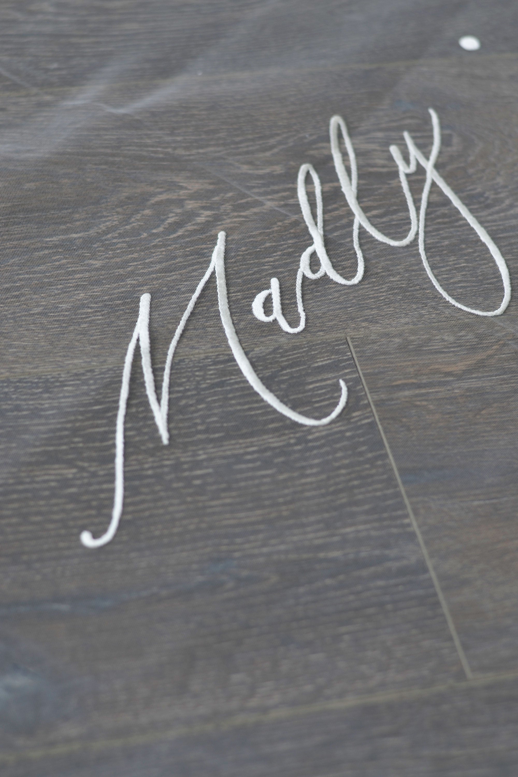 A wedding veil with embroidery text Truly • Madly • Deeply